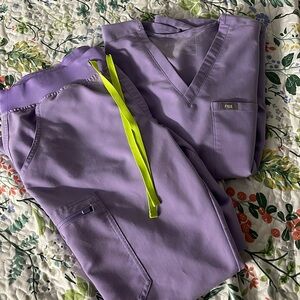 Figs lavender scrubs with neon green tie